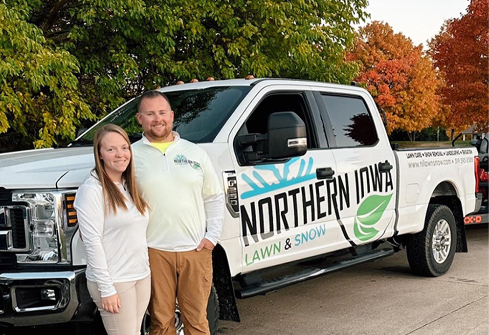 Eric and Amanda Blohm next to Northern Iowa Lawn and Snow Truck