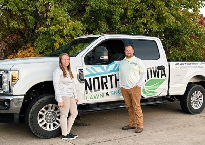 Eric and Amanda Blohm next to Northern Iowa Lawn and Snow Truck