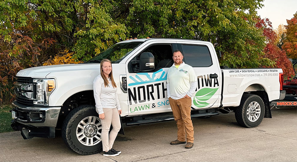 Eric and Amanda Blohm next to Northern Iowa Lawn and Snow Truck